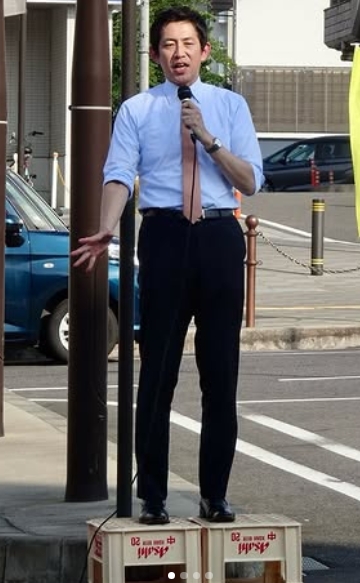 ビールケースの上に立ちスーツ姿で街頭演説する小林鷹之